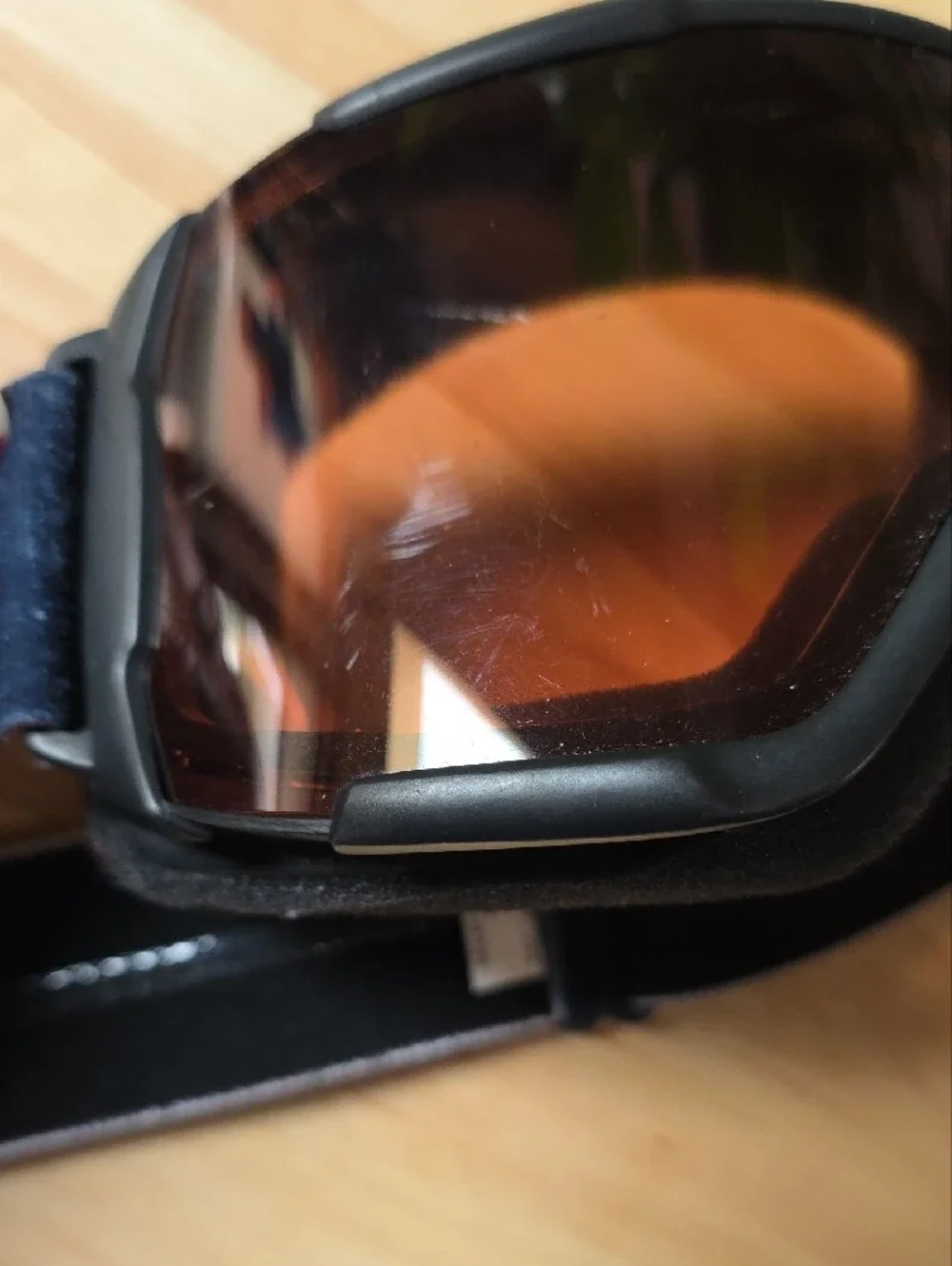 Smith Optics snow goggles featuring a black strap with white branding